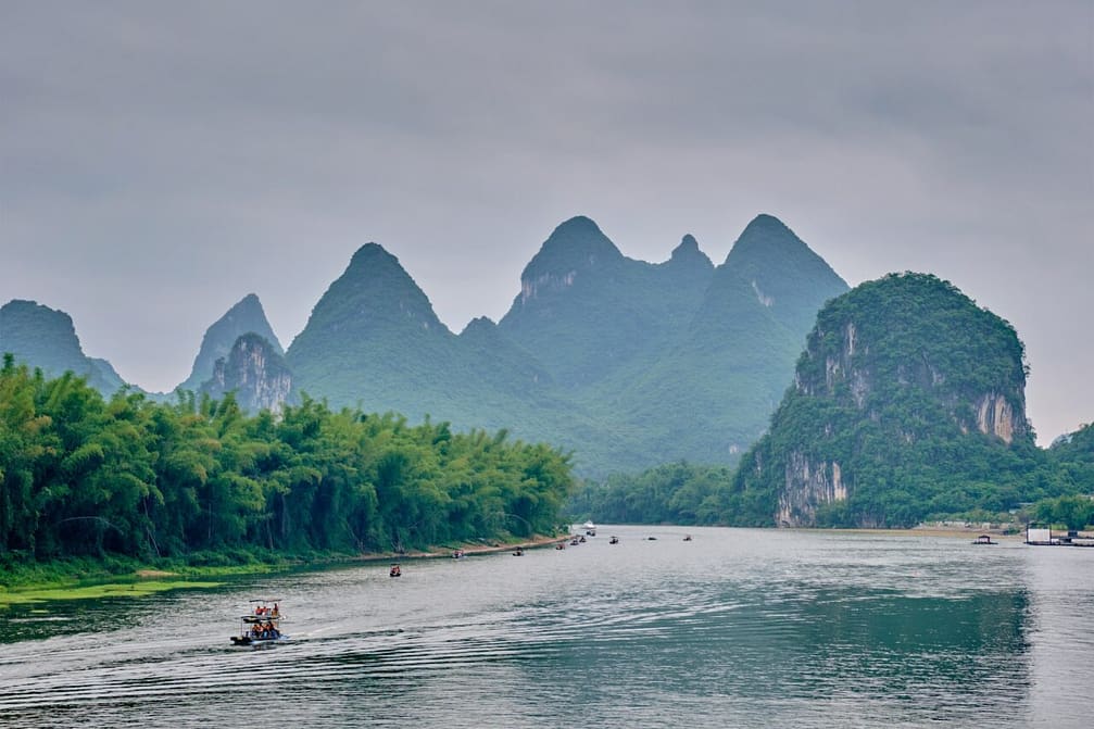 Tourist boats on Li river with carst mountains in the background