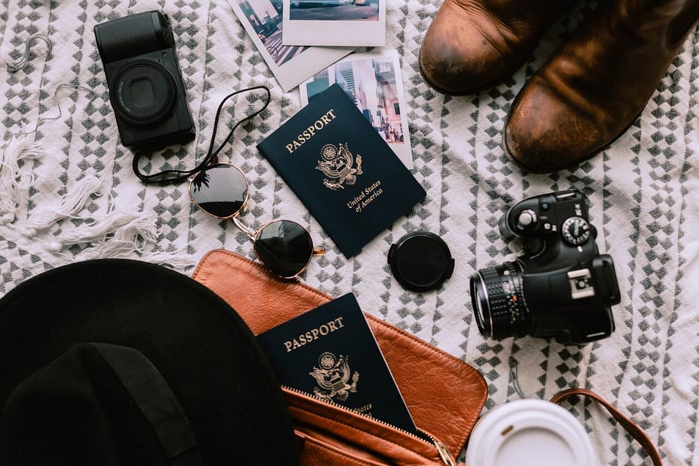 Travel flat lay. Packing stuff for trip. Traveling. Passport, cameras, photos. Memories. Backpacking