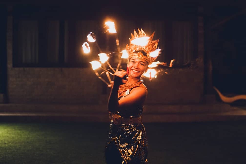 Balinese traditional dancing with fire show at evening beach party