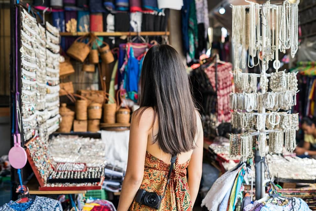 Young woman traveler at ubud market in bali