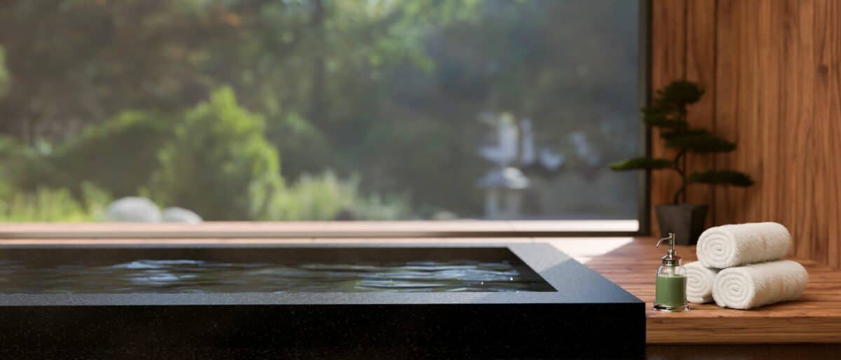 close-up image, Luxury jacuzzi tub or Japanese Onsen bath against the large glass wall