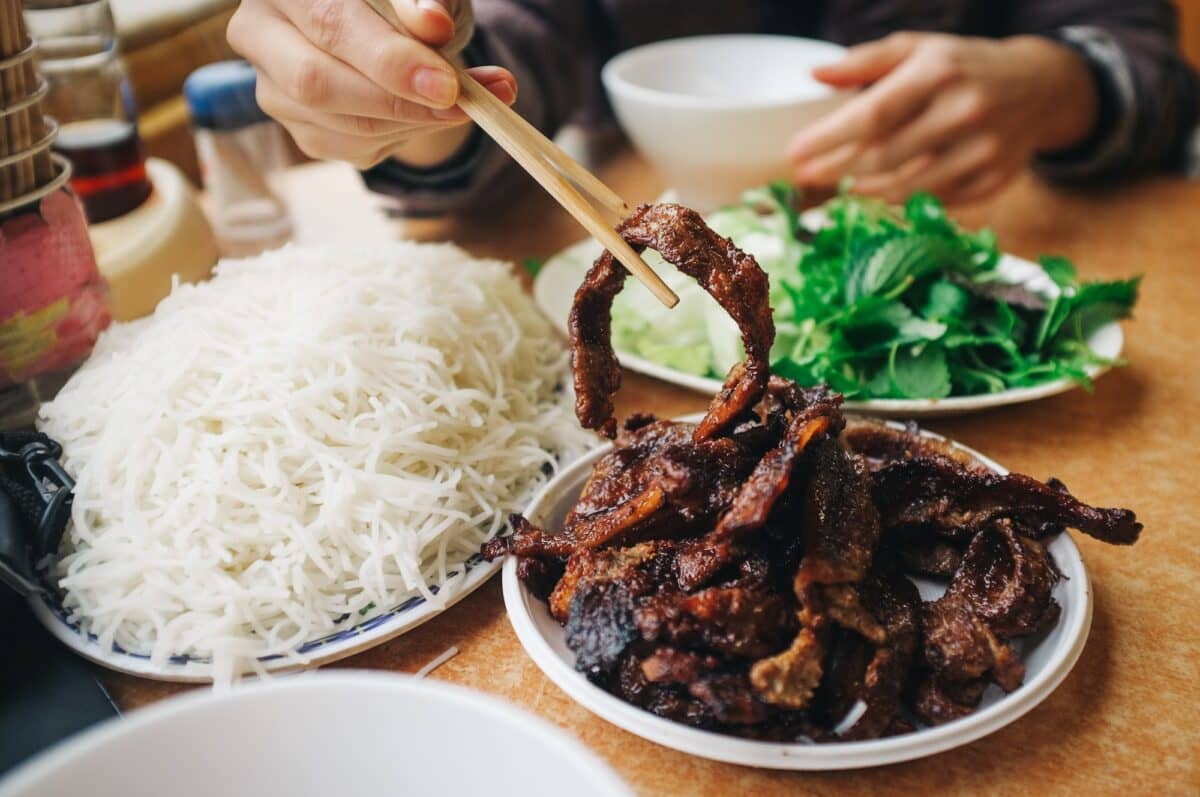 Eating Vietnamese bun cha with chopsticks
