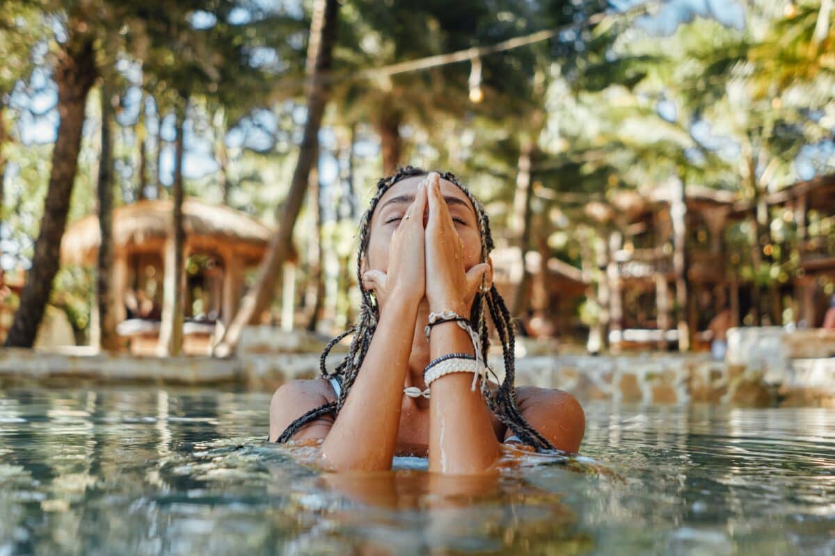 Woman enjoying swimming in pool in bali hotel
