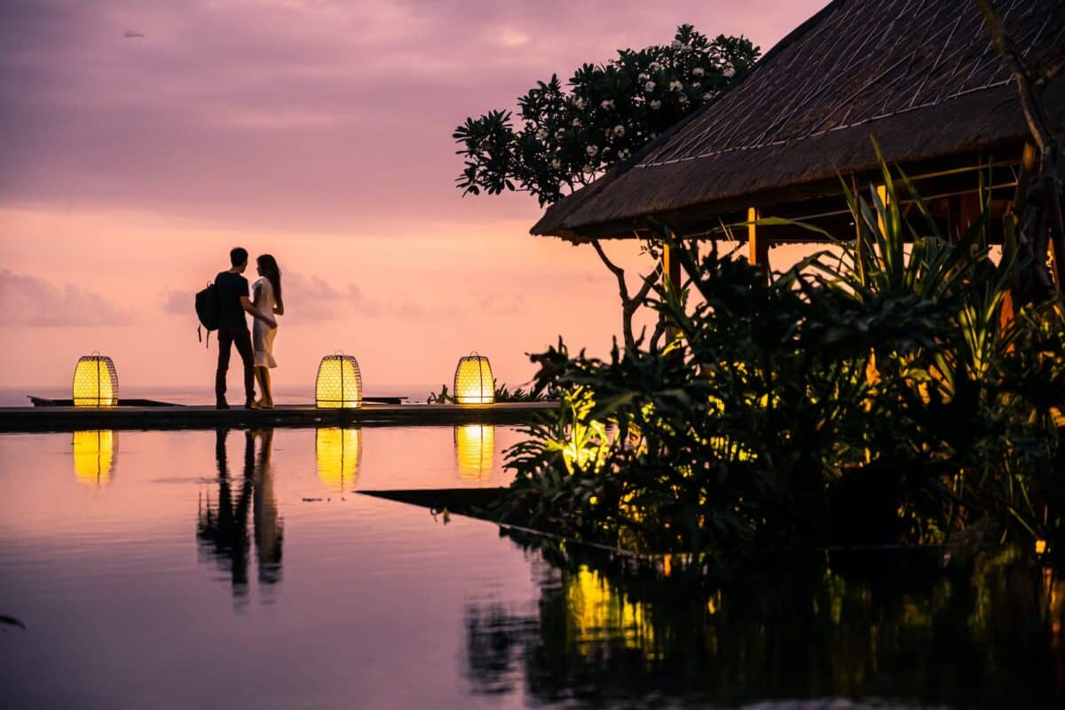 A young couple enjoying the lovely sunset at a resort in Bali.