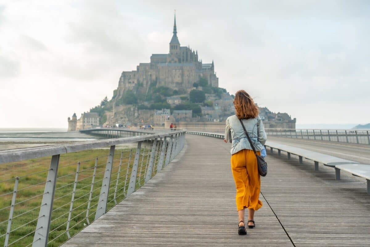 A young tourist visiting the famous Mont Saint-Michel, Normandy region, France