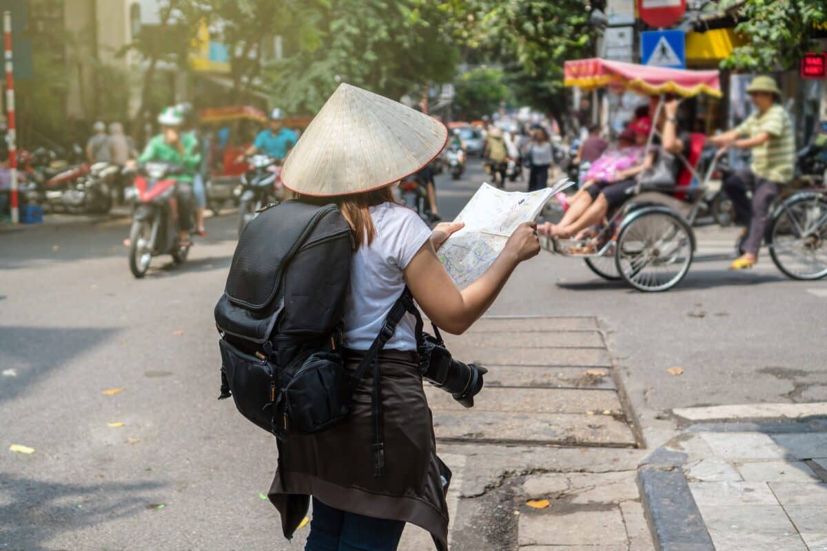 Asian Traveler holding and looking the map for travel at the hanoi city, vietnam