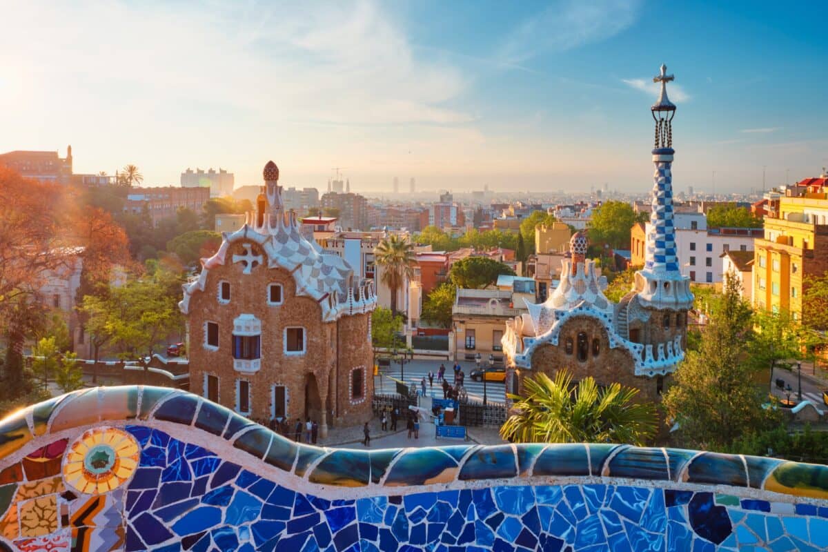 Barcelona city view from Guell Park. Sunrise view of colorful mosaic building in Park Guell