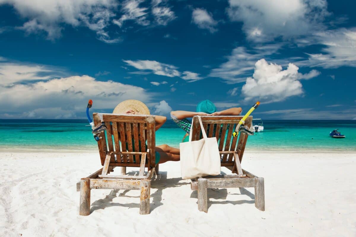 Couple in green relax on a beach at Maldives