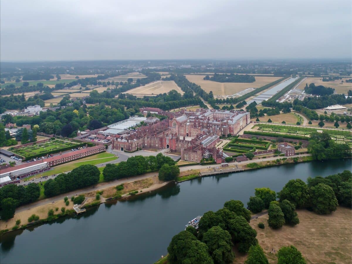 Aerial photography shot of the Hampton Court Palace beside the River Thames in the UK