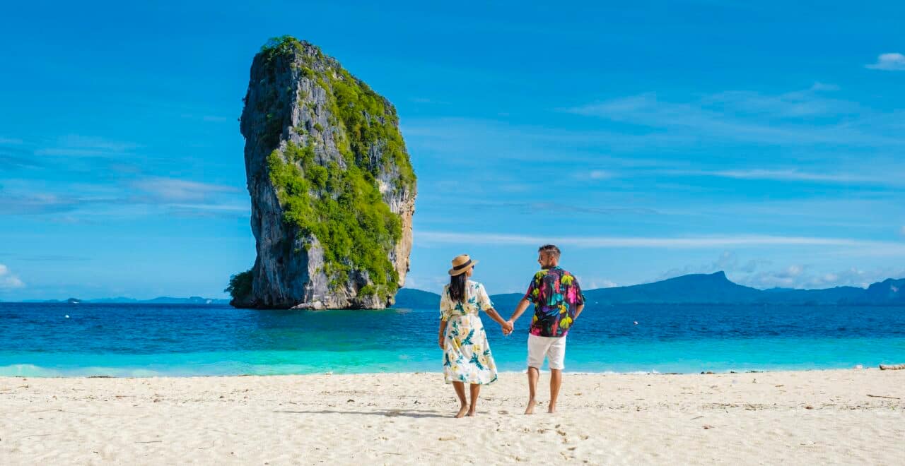 Koh Poda Krabi Thailand, Asian woman and European men walking on the tropical beach of Koh Poda