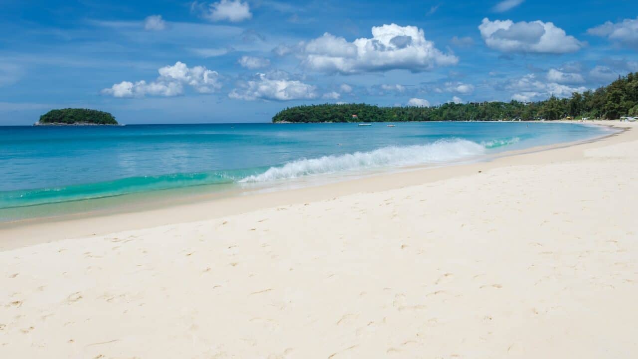 Kata beach Phuket Thailand on a sunny day with a blue sky