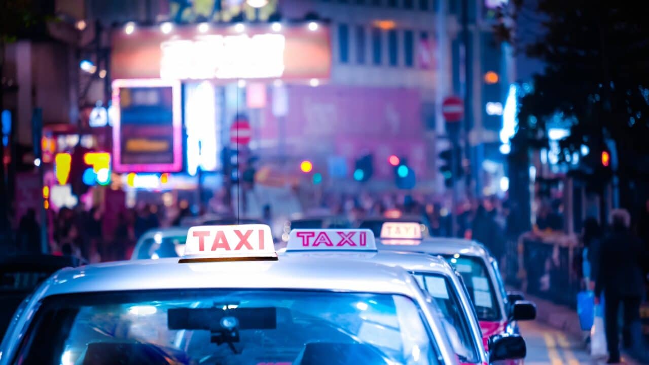 Hong Kong cityscape with taxi car at night city street