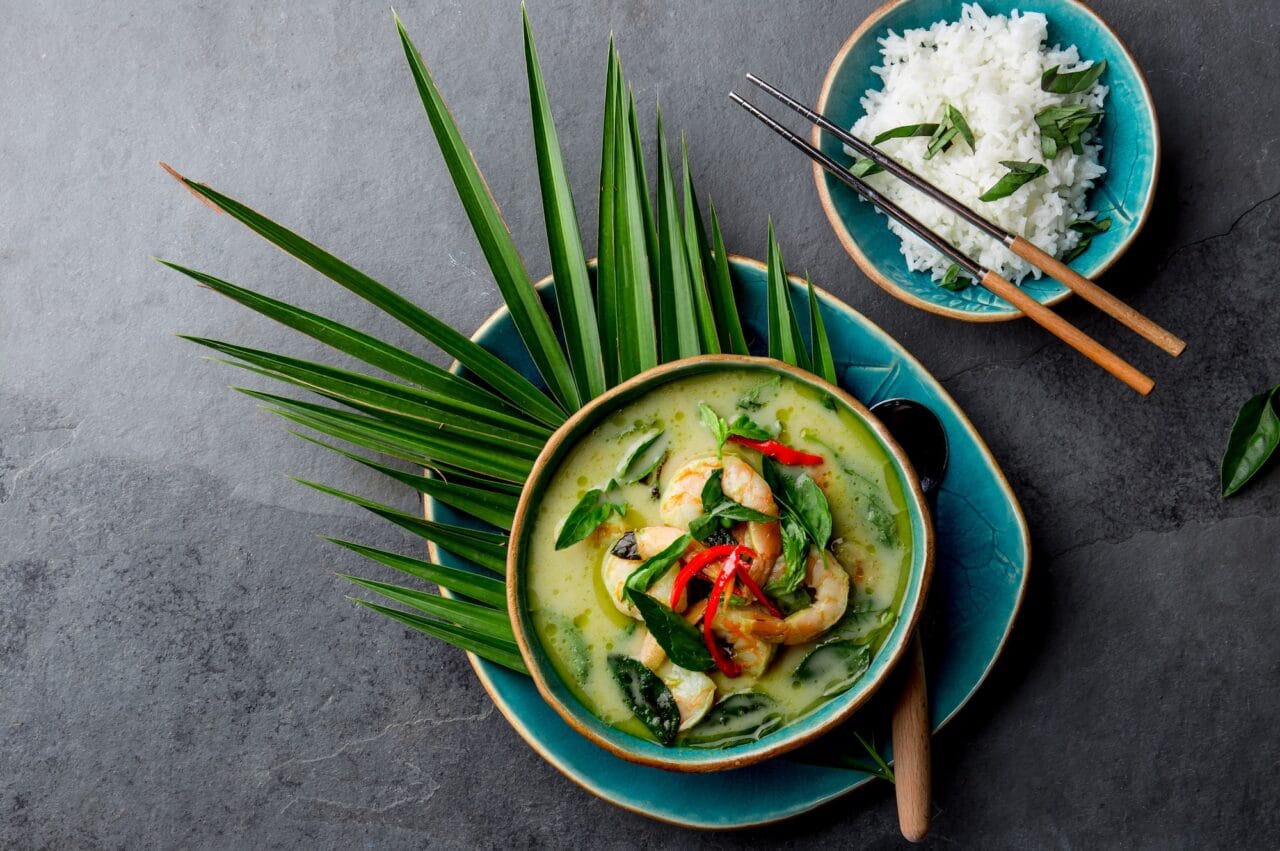 THAI SHRIMPS GREEN CURRY. Thailand tradition green curry soup with shrimps prawns and coconut milk