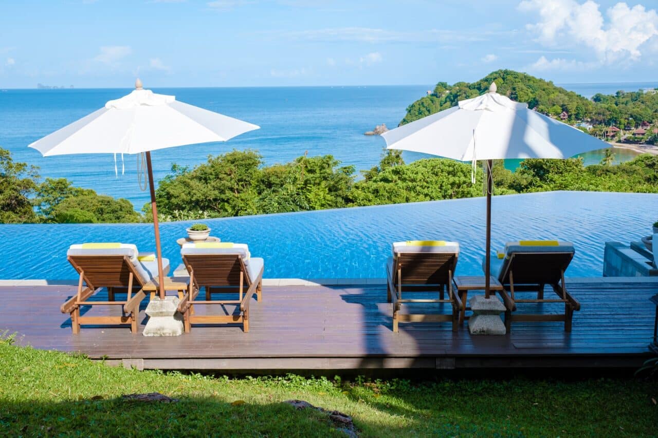 Beach Chairs on the beach of Koh Lanta, beach chairs with umbrella by a pool