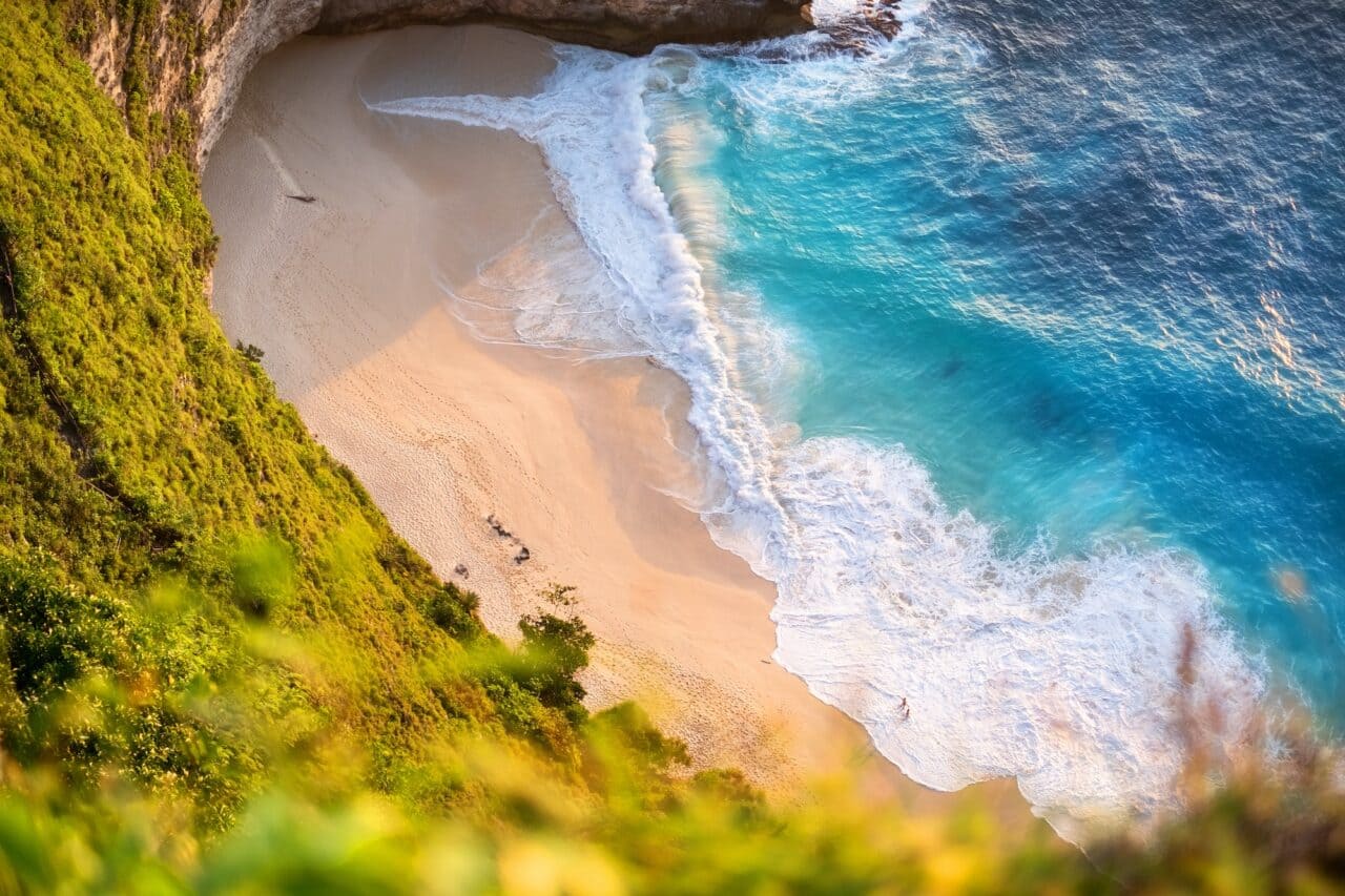 Beach Club on Bali, Indonesia. Vacation and adventure. Beach and turquoise water. Top view from drone