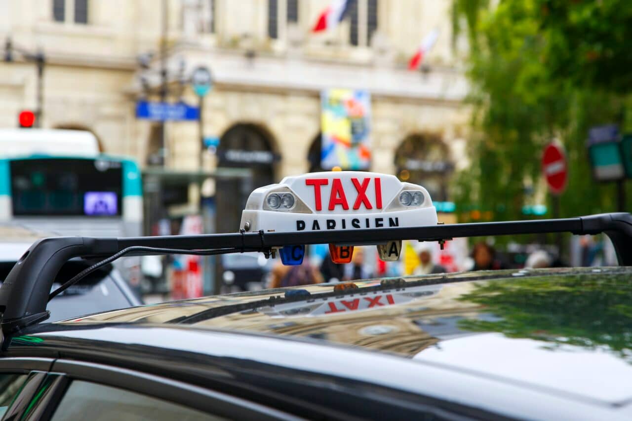 Tourists get around Paris by taxi