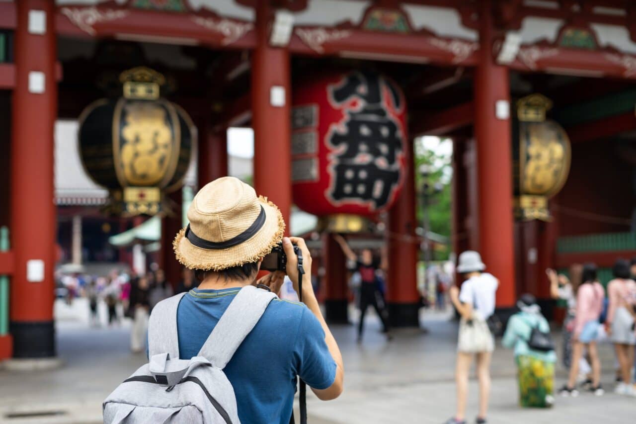 Young traveler taking photo of Sensoji temple in asakusa, Tokyo, Japan