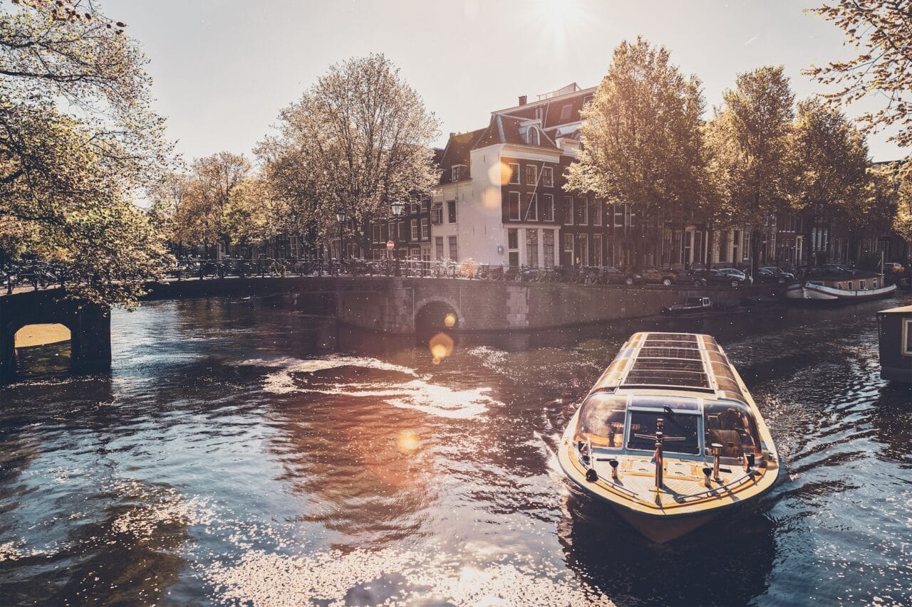 Amsterdam canal with tourist boat