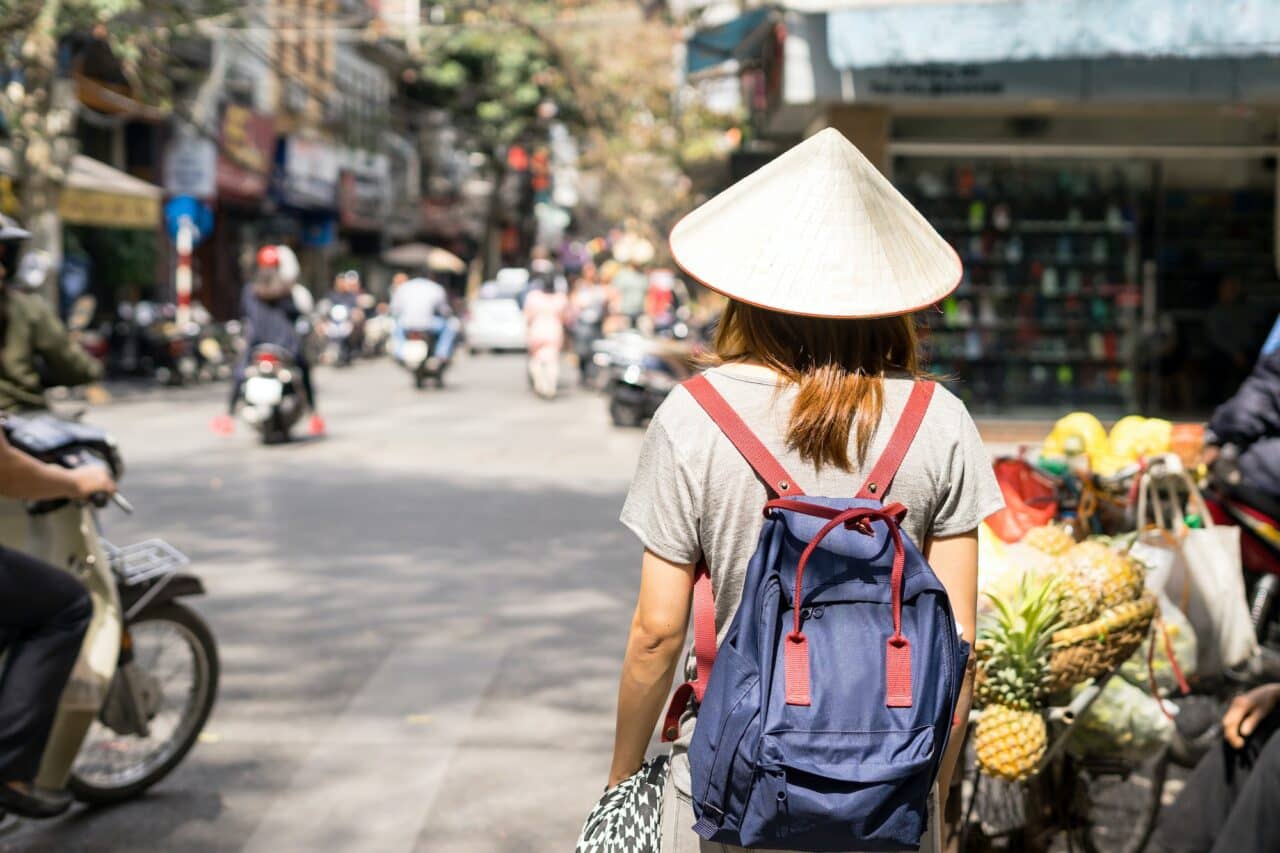 Young traveler with backpack at old quarter in Hanoi