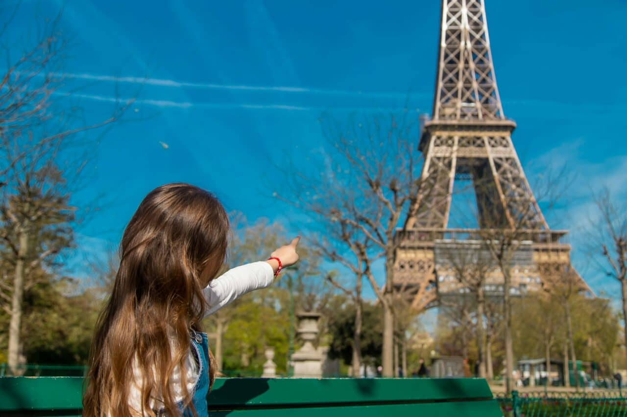 Children in Paris near the Eiffel Tower. Selective focus.