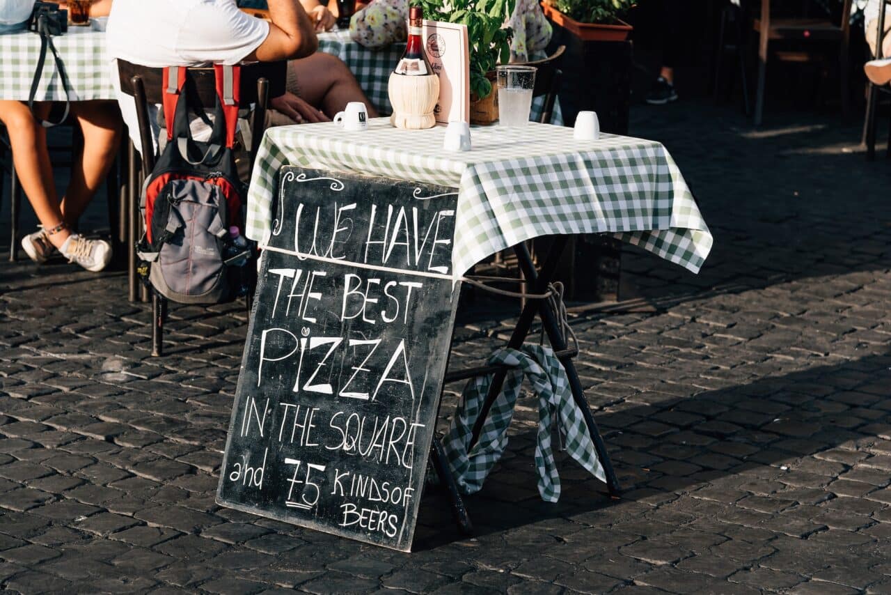 Sidewalk pizzeria in Rome a sunny summer day, Italy.