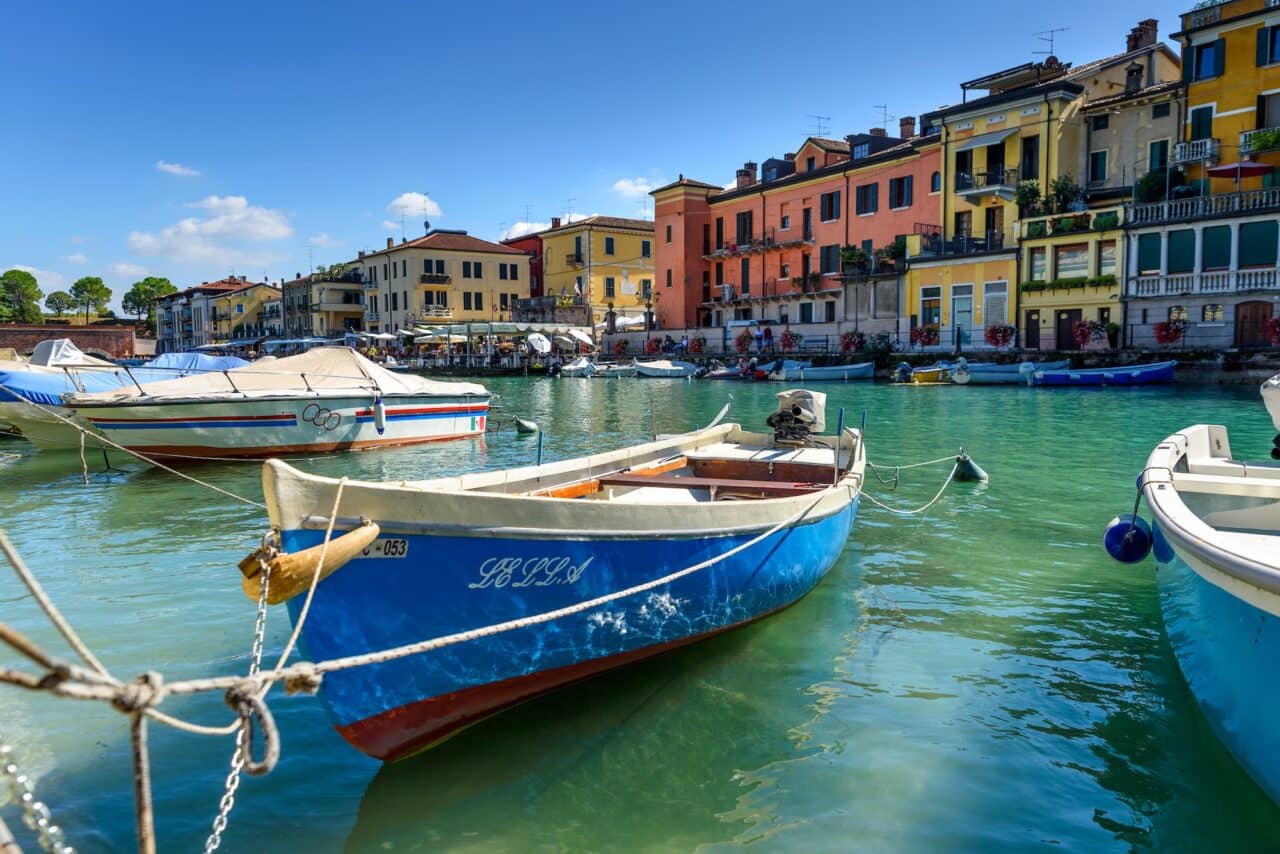 Boats moored along Lago di Garda for vacationers seeking Northern European sunshine.