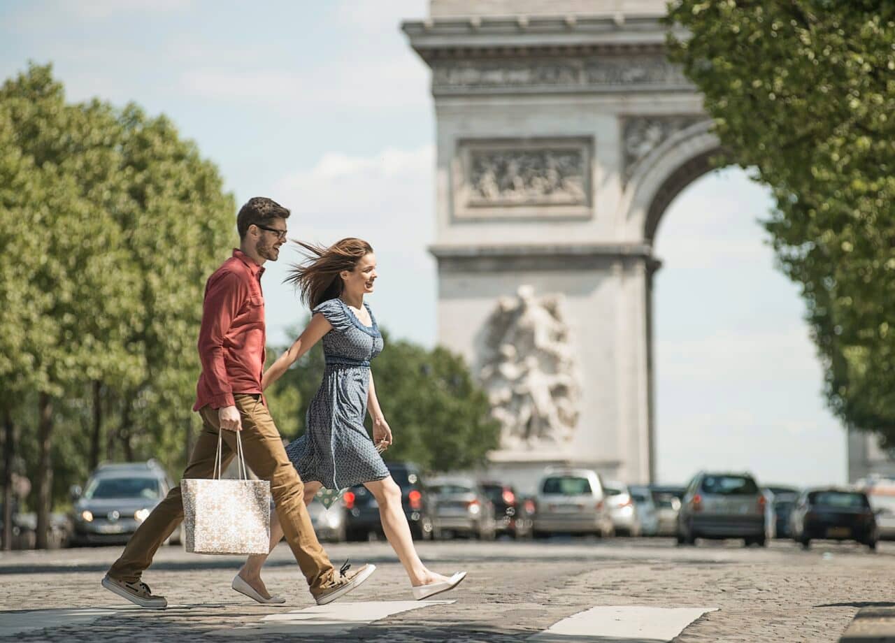 A couple hand in hand walking in Paris